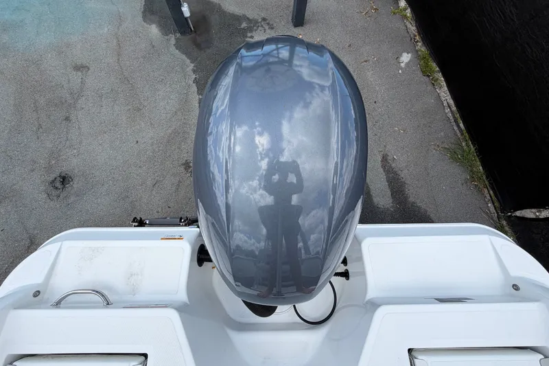 Slide: The Image of 2023 Wellcraft 202 Fisherman boat engine, top view with reflection of sky. - 54