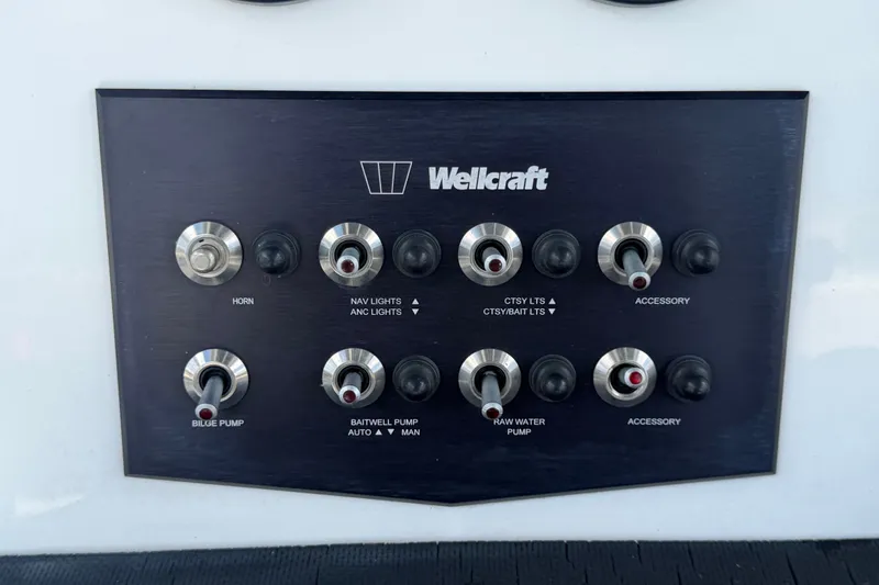 Slide: The Image of Control panel of 2023 Wellcraft 202 Fisherman boat with various switches. - 18