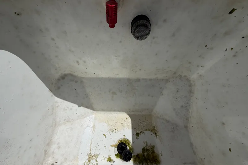 Slide: The Image of Dirty interior of a 2023 Wellcraft 202 Fisherman boat compartment. - 31