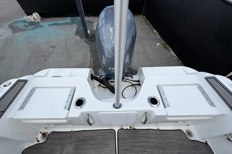 Slide: The Image of 2023 Wellcraft 202 Fisherman boat stern with outboard motor and deck features. - 52