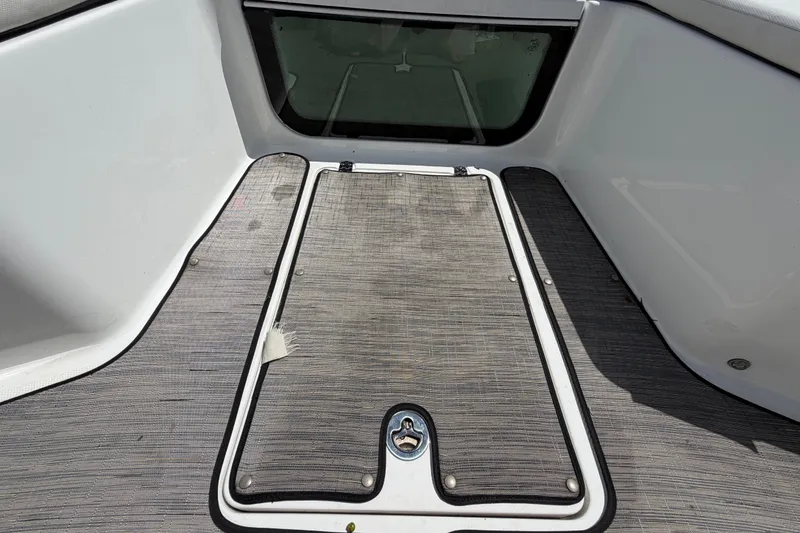 Slide: The Image of 2023 Wellcraft 202 Fisherman boat deck with storage compartment. - 26