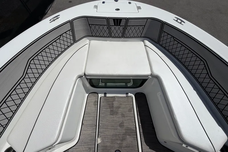 Slide: The Image of The image shows the bow of a Wellcraft 202 Fisherman boat with cushioned seating and storage. - 25