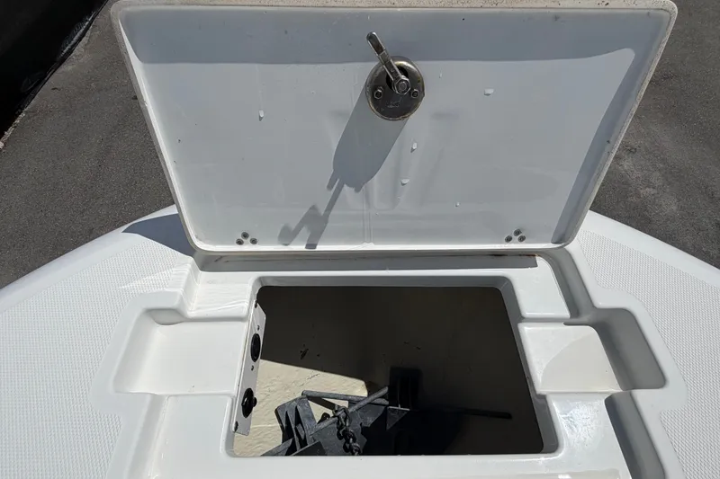Slide: The Image of Open anchor compartment on 2023 Wellcraft 202 Fisherman boat, showcasing storage space. - 33
