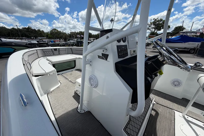 Slide: The Image of 2023 Wellcraft 202 Fisherman boat interior with steering console and seating area. - 23
