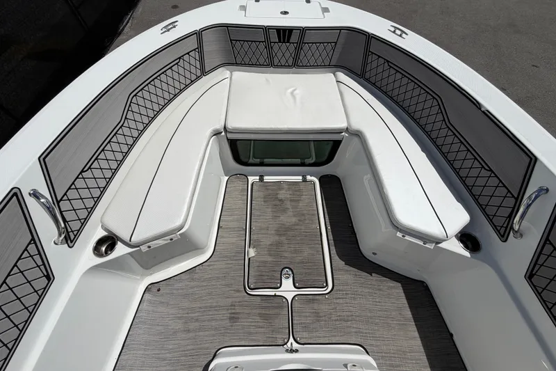 Slide: The Image of 2023 Wellcraft 202 Fisherman boat interior with cushioned seating and storage compartments. - 24