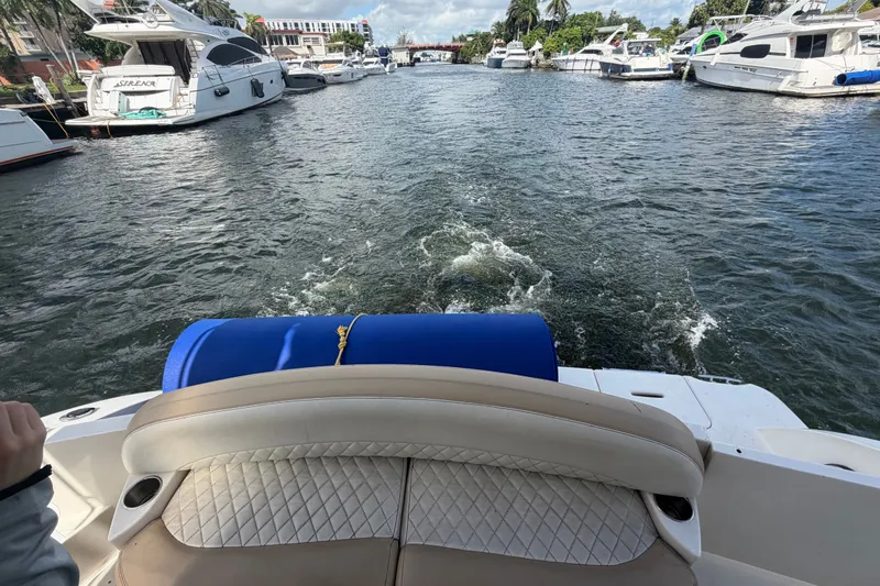 Slide: The Image of 2008 Meridian 391 Sedan cruising through a marina with yachts docked on both sides. - 94