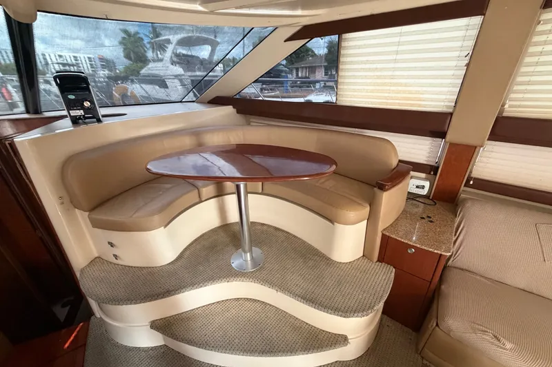 Slide: The Image of Interior of 2008 Meridian 391 Sedan yacht with curved seating and wooden table. - 40