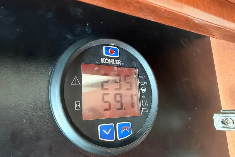 Slide: The Image of Kohler generator display on 2008 Meridian 391 Sedan, showing voltage and frequency readings. - 92