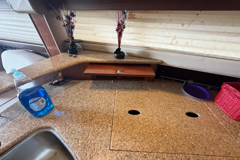 Slide: The Image of Interior of 2008 Meridian 391 Sedan with granite countertop and cleaning supplies. - 54