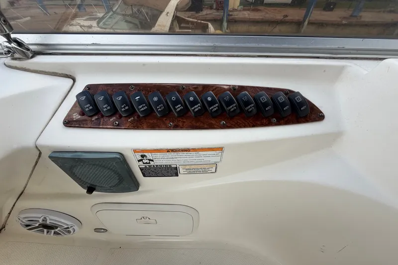 Slide: The Image of Control panel of a 2008 Meridian 391 Sedan boat with labeled switches. - 12