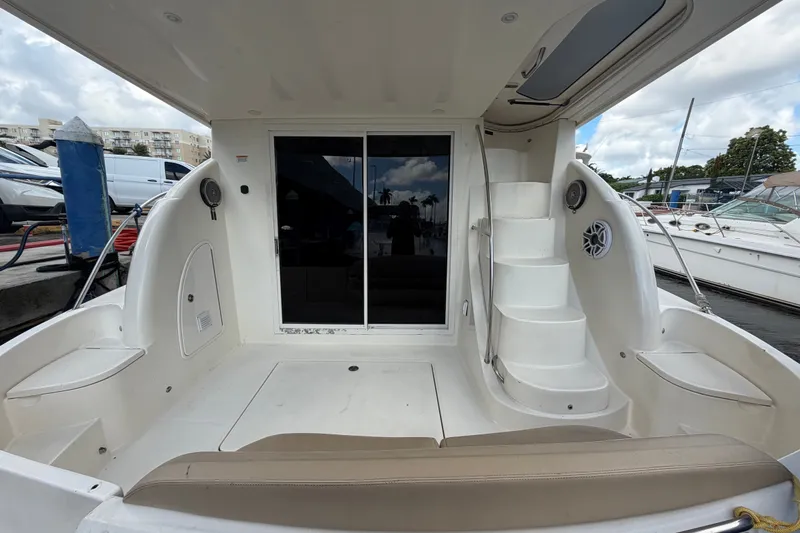 Slide: The Image of 2008 Meridian 391 Sedan yacht cockpit with seating, stairs, and marina view. - 30