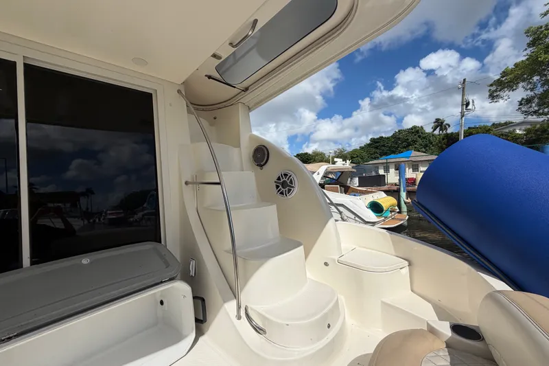 Slide: The Image of 2008 Meridian 391 Sedan yacht interior with stairs and seating, docked under a blue sky. - 26