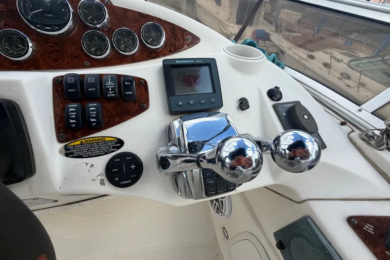 Slide: The Image of Control panel of a 2008 Meridian 391 Sedan boat with gauges and throttle levers. - 13