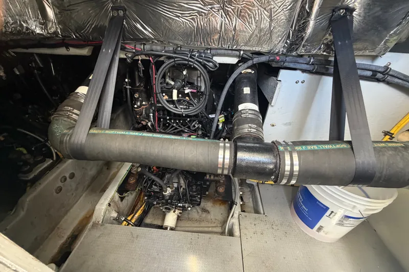 Slide: The Image of Engine room of a 2008 Meridian 391 Sedan with visible exhaust hoses and components. - 86