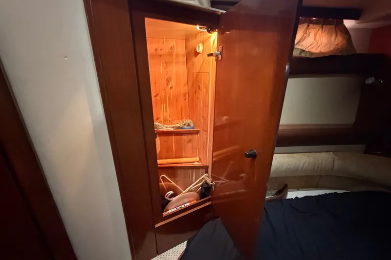 Slide: The Image of 2008 Meridian 391 Sedan interior with open wooden closet and cozy cabin space. - 76