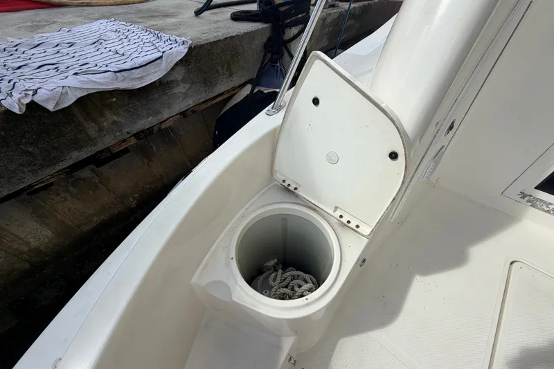 Slide: The Image of Open storage compartment on 2008 Meridian 391 Sedan boat deck with coiled rope inside. - 33