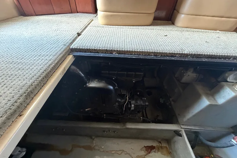 Slide: The Image of Engine compartment of a 2008 Meridian 391 Sedan yacht, partially exposed under carpeted flooring. - 79
