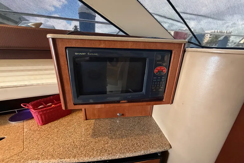 Slide: The Image of Microwave in 2008 Meridian 391 Sedan yacht kitchen with wooden cabinetry. - 51