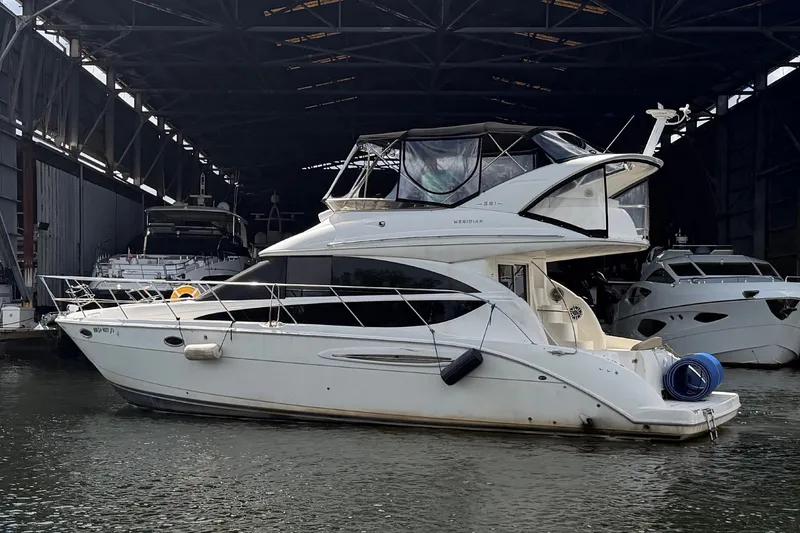 Slide: The Image of 2008 Meridian 391 Sedan yacht docked in a marina, under a large shelter. - 2
