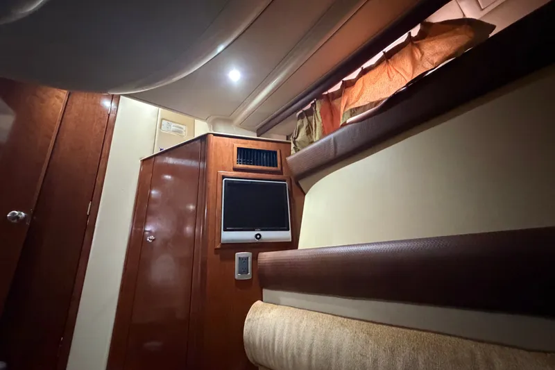 Slide: The Image of Interior of 2008 Meridian 391 Sedan yacht with wood paneling and built-in TV. - 77