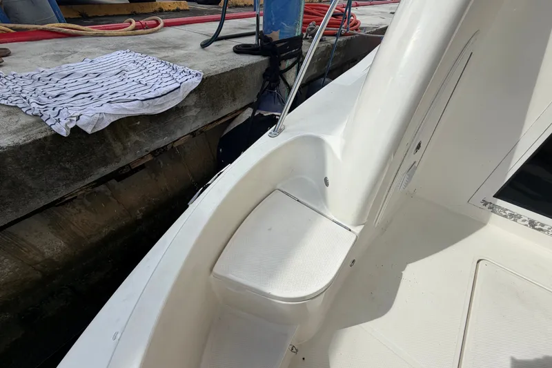 Slide: The Image of 2008 Meridian 391 Sedan boat docked, showing clean white deck and nearby dock. - 32