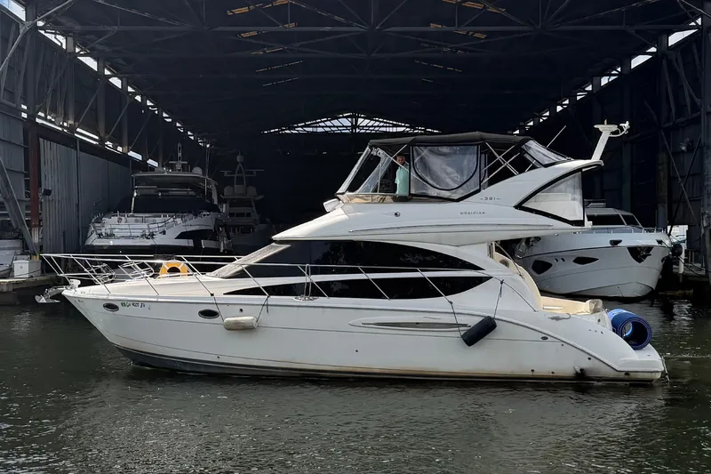 Slide: The Image of 2008 Meridian 391 Sedan yacht docked in a covered marina. - 1