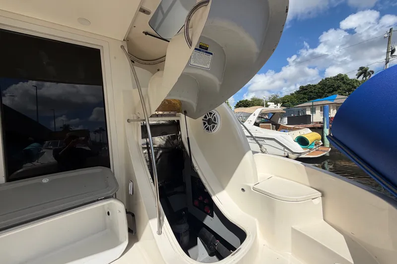 Slide: The Image of 2008 Meridian 391 Sedan yacht interior with open hatch, docked under a blue sky. - 27