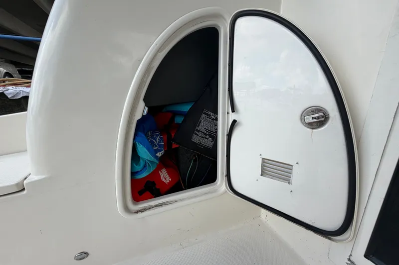 Slide: The Image of Storage compartment on a 2008 Meridian 391 Sedan boat, containing life jackets. - 37