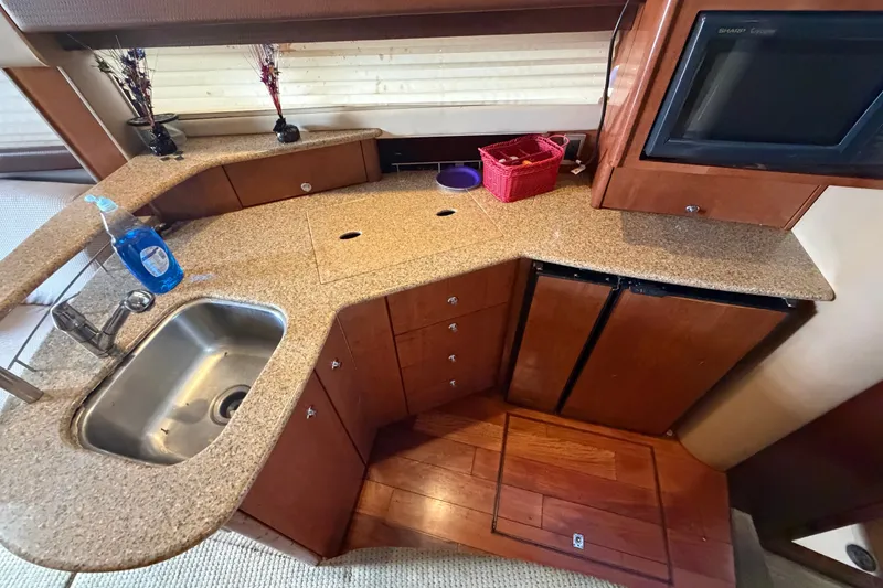 Slide: The Image of 2008 Meridian 391 Sedan yacht kitchen with granite countertops and stainless steel sink. - 48