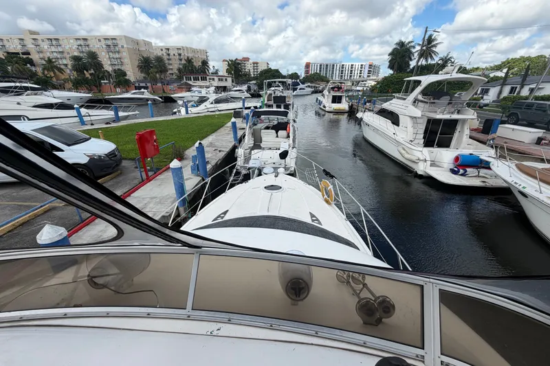 Slide: The Image of 2008 Meridian 391 Sedan yacht docked in a marina with other boats and buildings nearby. - 18