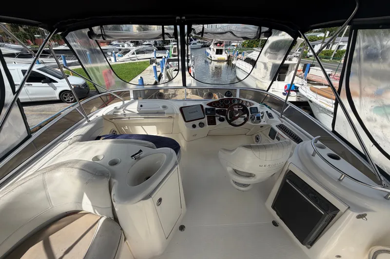 Slide: The Image of 2008 Meridian 391 Sedan yacht cockpit with steering wheel, navigation equipment, and seating area. - 10