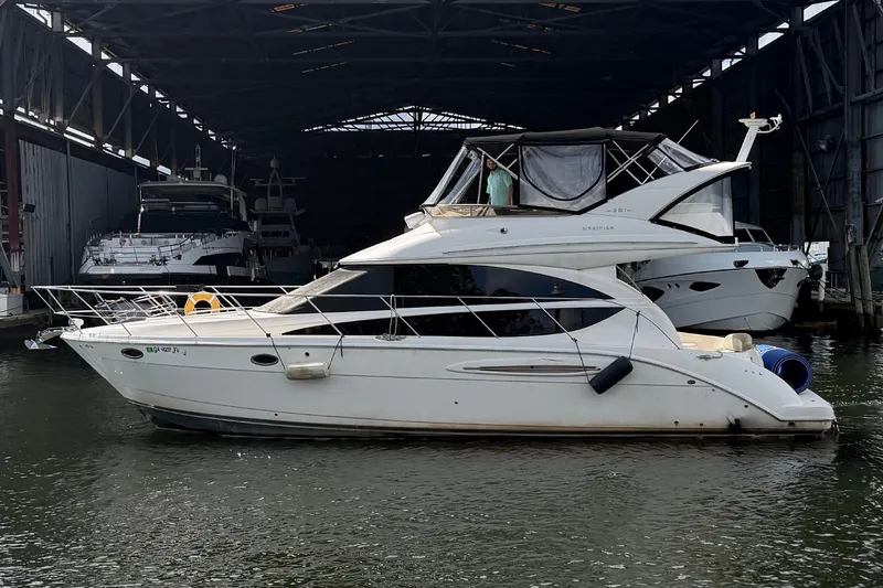 Slide: The Image of 2008 Meridian 391 Sedan yacht docked in a marina under a covered structure. - 0