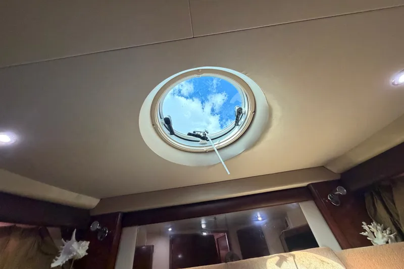 Slide: The Image of Interior view of 2008 Meridian 391 Sedan yacht with circular skylight and blue sky. - 66