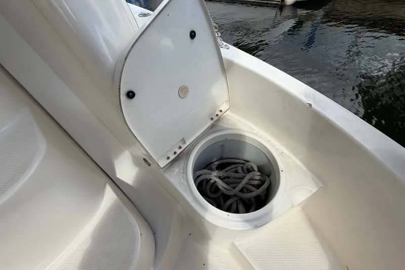 Slide: The Image of Open storage compartment on 2008 Meridian 391 Sedan boat with coiled rope inside. - 35