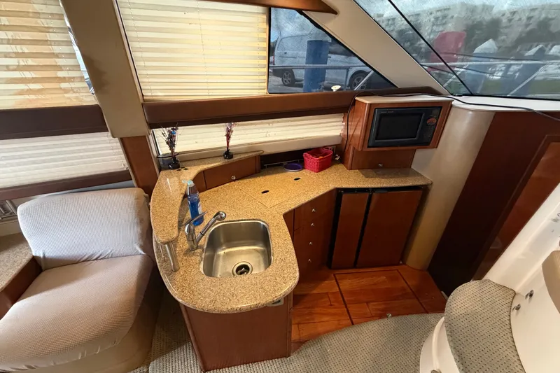 Slide: The Image of Interior of 2008 Meridian 391 Sedan yacht with kitchenette and seating area. - 47