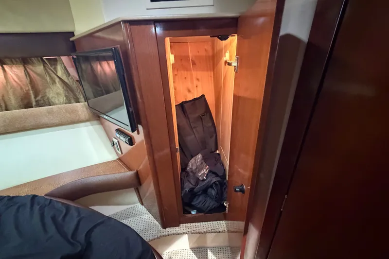 Slide: The Image of Interior of a 2008 Meridian 391 Sedan yacht showing a wooden storage cabinet. - 70