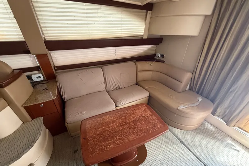 Slide: The Image of Luxurious interior of a 2008 Meridian 391 Sedan yacht with plush seating and wooden table. - 41