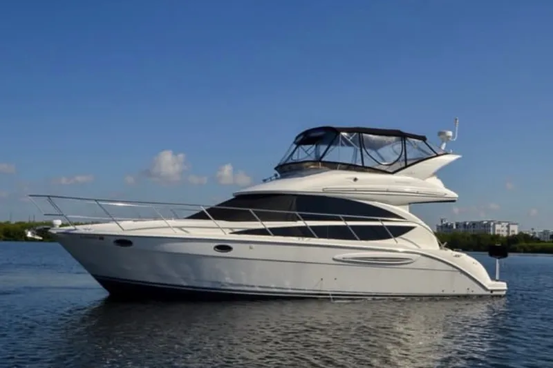 Slide: The Image of 2008 Meridian 391 Sedan yacht on calm water under clear blue sky. - 1