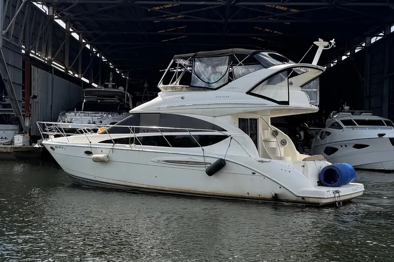 Slide: The Image of 2008 Meridian 391 Sedan yacht docked in a marina, under a large shelter. - 3