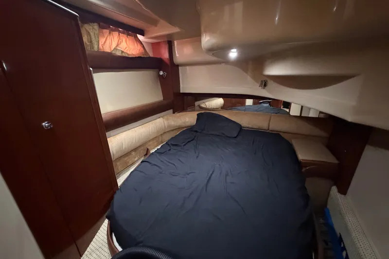 Slide: The Image of Interior cabin of a 2008 Meridian 391 Sedan yacht with cozy bed and wood accents. - 74