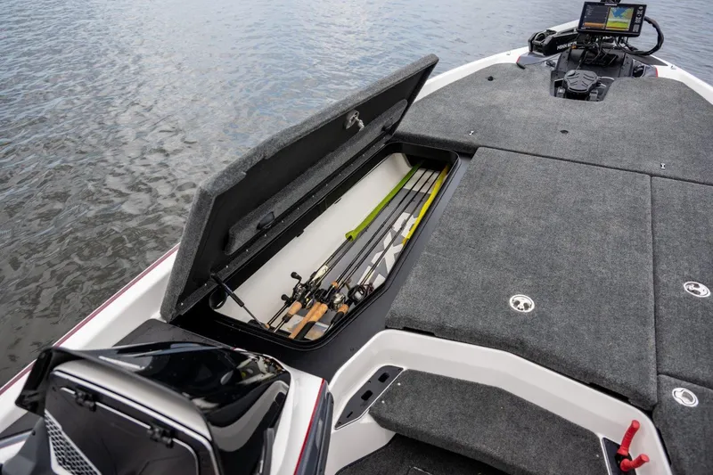 Slide: The Image of Manufacturer Provided Image: 2024 Skeeter FXR21 Apex boat with open storage compartment holding fishing rods. - 17