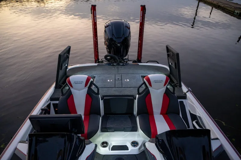 Slide: The Image of Manufacturer Provided Image: 2024 Skeeter FXR21 Apex boat interior with dual seats and motor at sunset. - 18