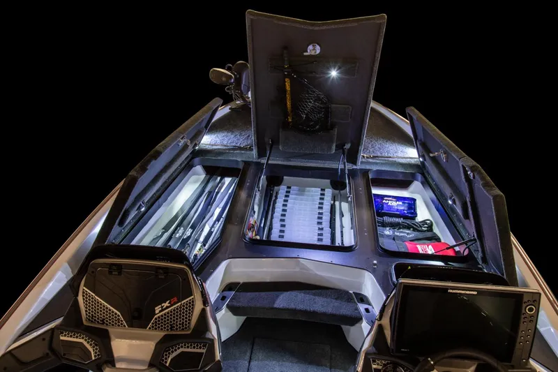 Slide: The Image of Manufacturer Provided Image: 2024 Skeeter FXR21 Apex boat interior with storage compartments and fishing gear. - 14