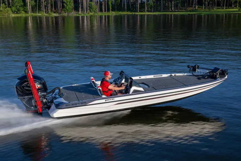 The Image of Manufacturer Provided Image: 2024 Skeeter FXR21 Apex boat speeding on a lake with a driver in red attire. - 11