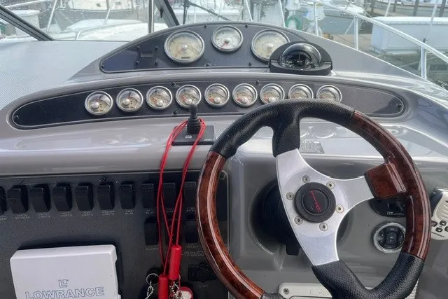 Slide: The Image of 2006 Maxum 3300 SE boat dashboard with steering wheel and instrument panel. - 10