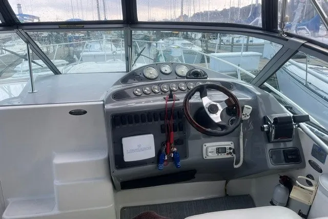 Slide: The Image of 2006 Maxum 3300 SE boat cockpit with steering wheel and control panel. - 8