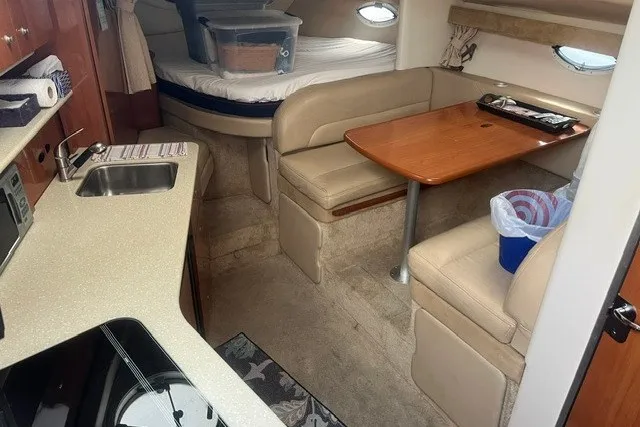 Slide: The Image of 2006 Maxum 3300 SE cabin interior with kitchenette, dining area, and sleeping quarters. - 13