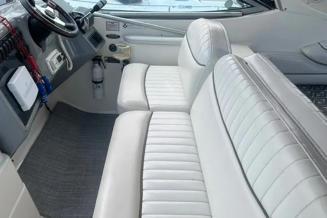 Slide: The Image of Interior of 2006 Maxum 3300 SE boat with white leather seating and dashboard. - 9