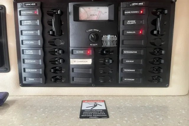 Slide: The Image of Electrical control panel on a 2006 Maxum 3300 SE boat with various switches and indicators. - 14