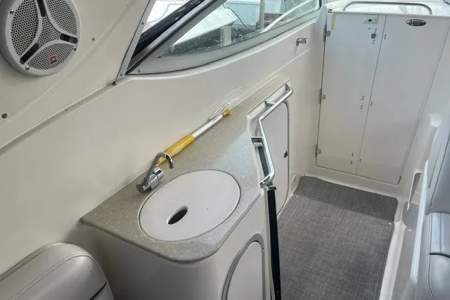 Slide: The Image of 2006 Maxum 3300 SE boat interior with sink, speaker, and storage cabinet. - 7
